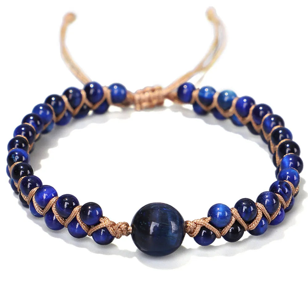 Handmade geometric pull bracelet woven from blue tigereye stone beads on a wrist.