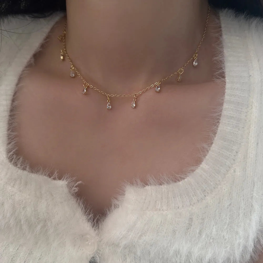 Women's zircon jewellery set showing geometric meteor shower design on necklace, earrings, and anklet
