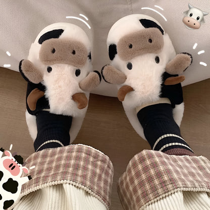 White cow-themed plush slippers with a non-slip textured sole for women.