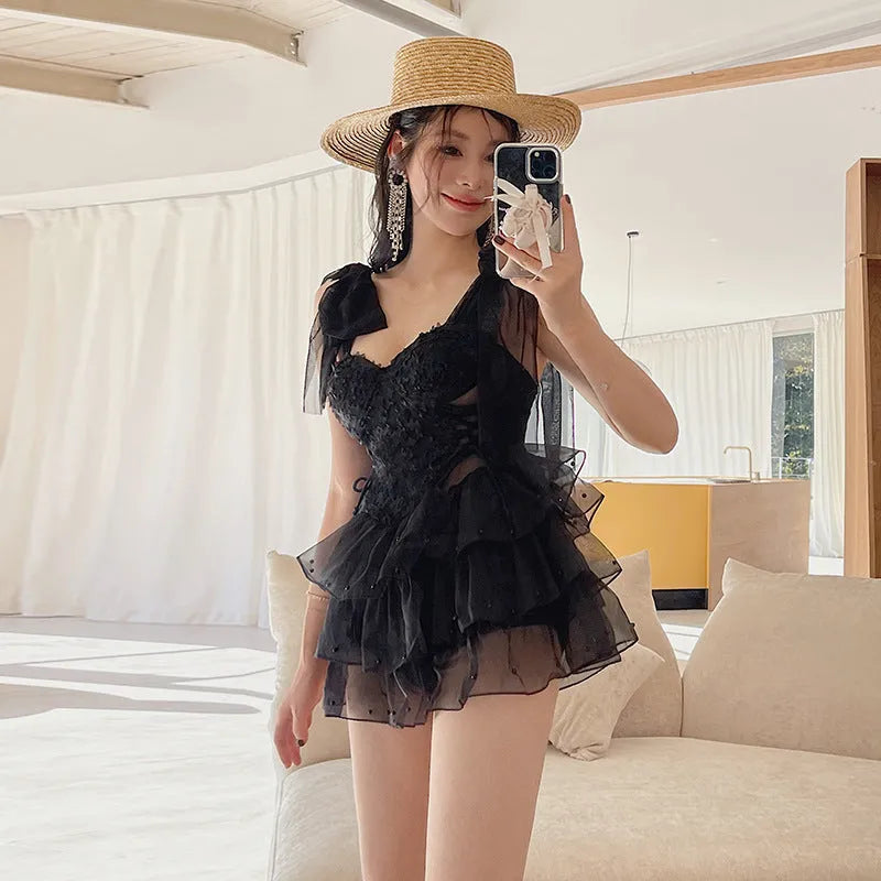 Black one-piece swimsuit with chest gathering design for conservative coverage, sleeveless with solid colour pattern