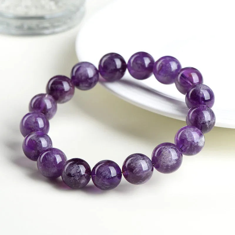 Natural feather amethyst bracelet with scattered purple crystal beads and Ruyi elements on wrist
