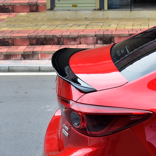 Mazda 3 Axela Exela tail trim in bright black with large fixed wind surround, showing precise fitment on vehicle rear