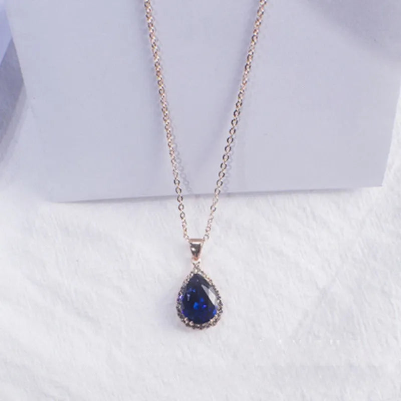 Rose gold geometric water drop pendant necklace on a model, showing adjustable chain and sparkling stone inlay.