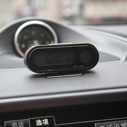 Black electronic car clock thermometer with LED display showing time and temperature, mounted on adjustable bracket