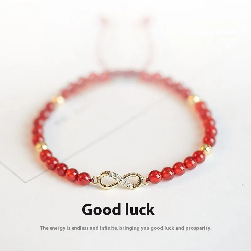 Hand-woven red agate beads bracelet with lucky charm in ethnic style, showing diamond-shaped beads.