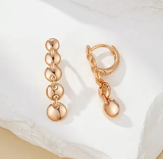 Gold finish hand-woven copper circle earrings showing textured surface and 5cm diameter
