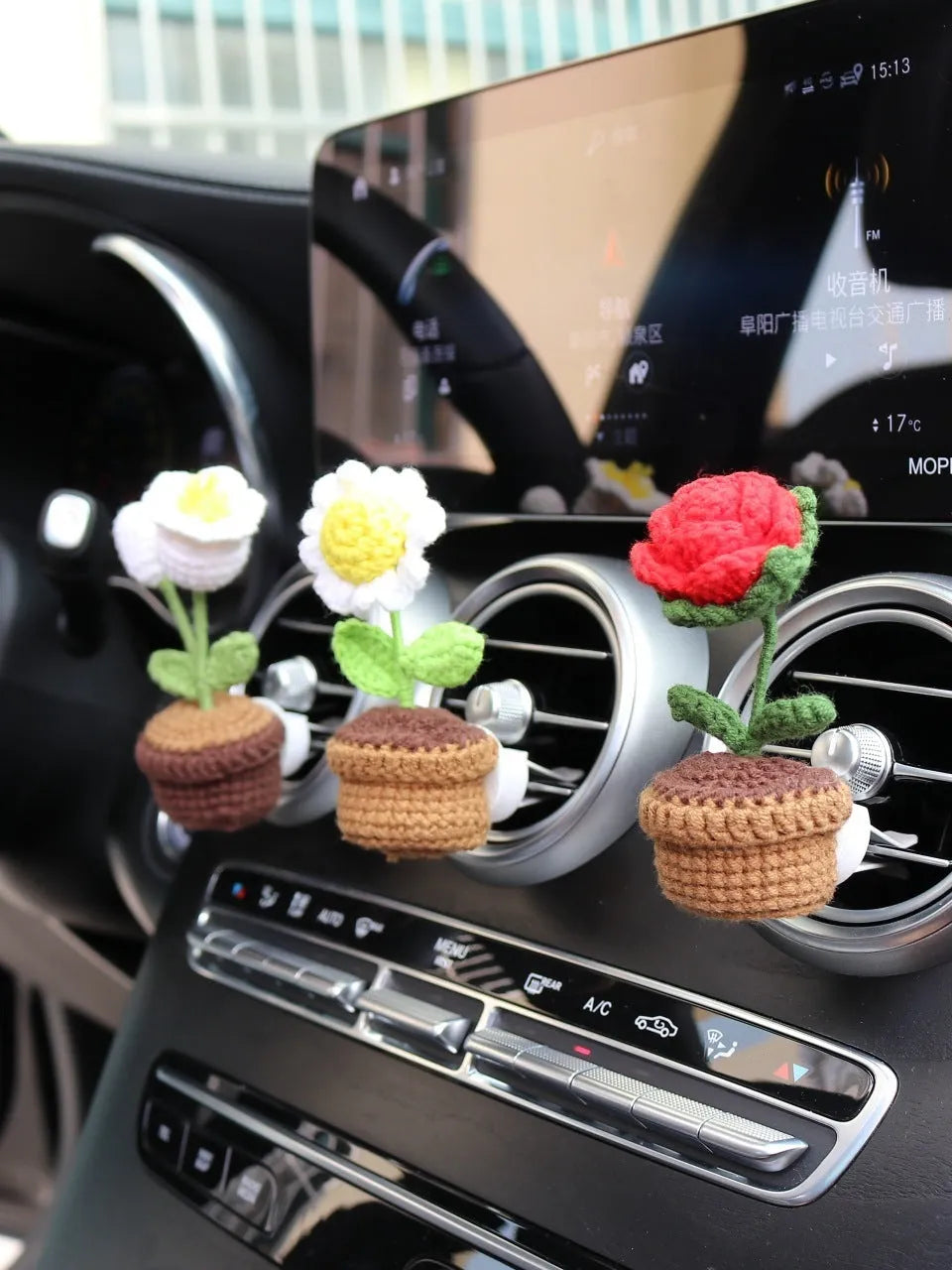 Creative wool potted plant car air vent clip aromatherapy pendant on a car vent.