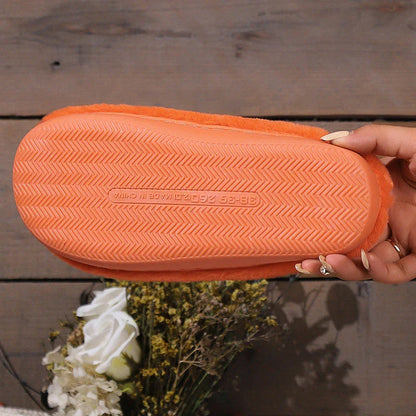 Cozy Halloween pumpkin-themed slippers with plush lining and non-slip soles for comfortable indoor wear