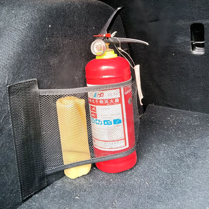 A stretchy polyester car boot storage net in a vehicle trunk, holding loose items securely.