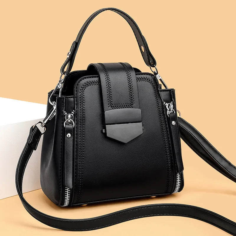 Soft PU leather ladies handbag with textured surface and sewing thread detailing in square vertical shape