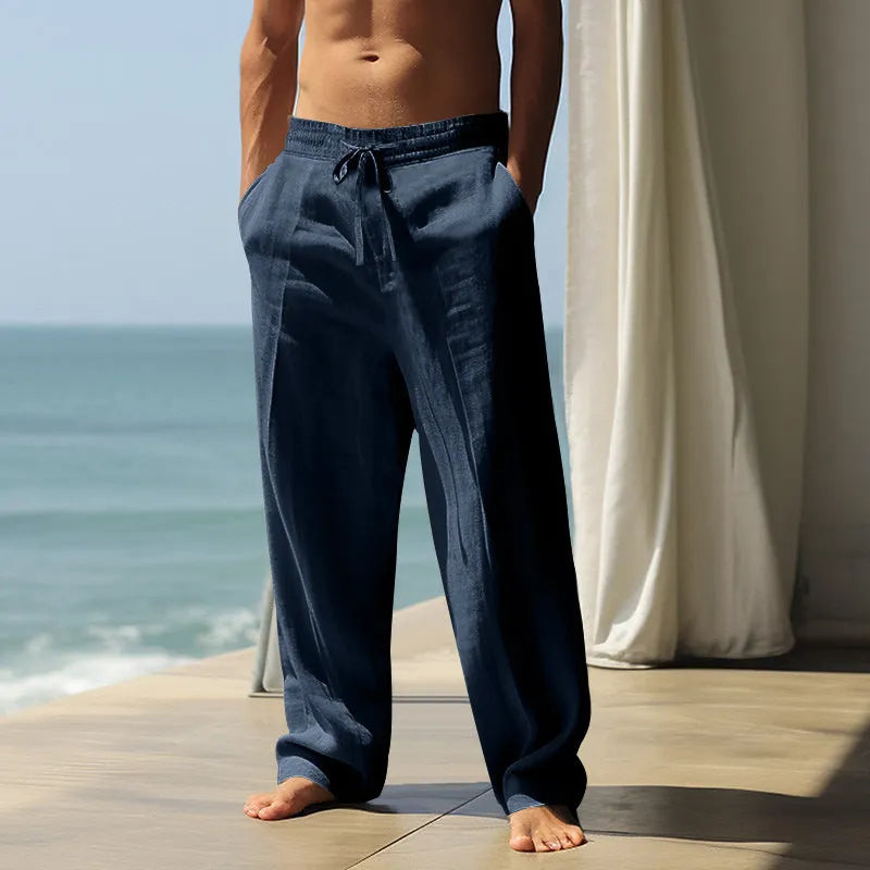 Man wearing loose-fit solid colour cotton casual trousers in grey, showing the relaxed fit and simple design.