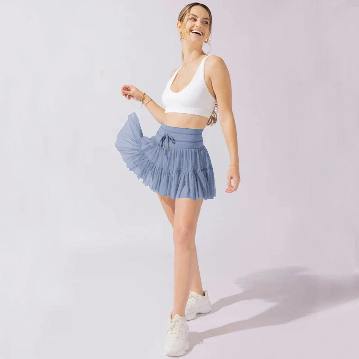 Stylish high-waist pleated mini skirt with lace-up design and built-in anti-exposure safety shorts, available in a variety of vibrant colors.