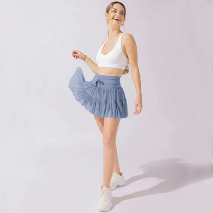 Stylish high-waist pleated mini skirt with lace-up design and built-in anti-exposure safety shorts, available in a variety of vibrant colors.