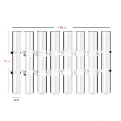 Clear glass hinged test tube vase with plants in curved arrangement