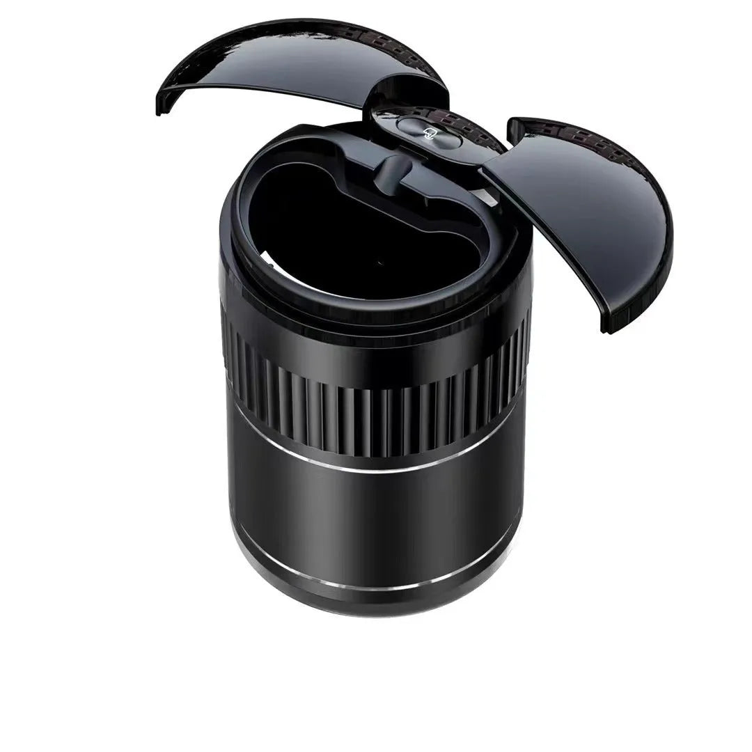 Compact black metal car ashtray with automatic lid on a car console