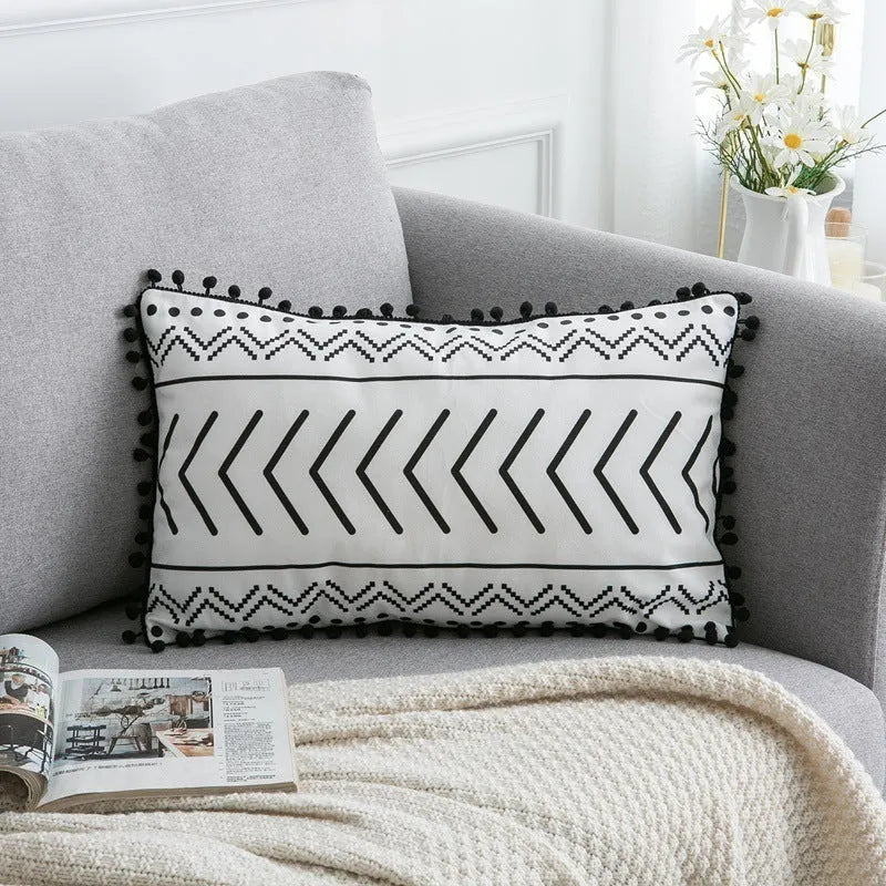 Bohemian style decorative pillowcase in light grey colour on a sofa.