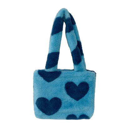 Soft, plush heart-shaped handbag in various vibrant colors with a magnetic closure and interior phone compartment