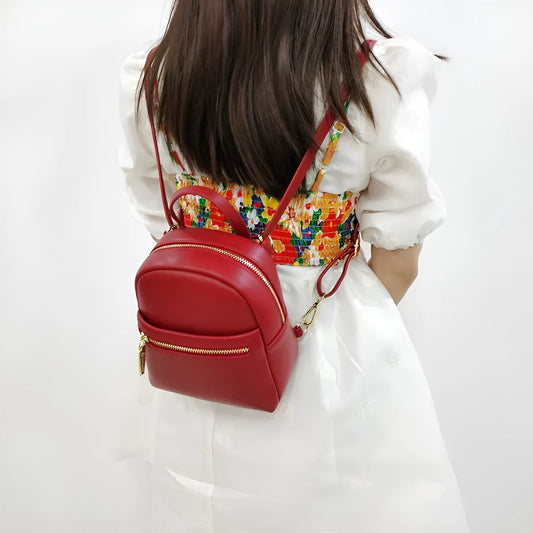 Soft PU mini backpack in multiple colours showing three-dimensional outer pockets and street style design.