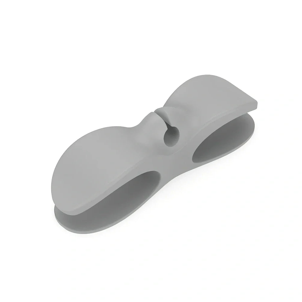 Black TPU cable organizer clips winding appliance cords on kitchen counter, 5cm size, non-marking adhesive for tidy management