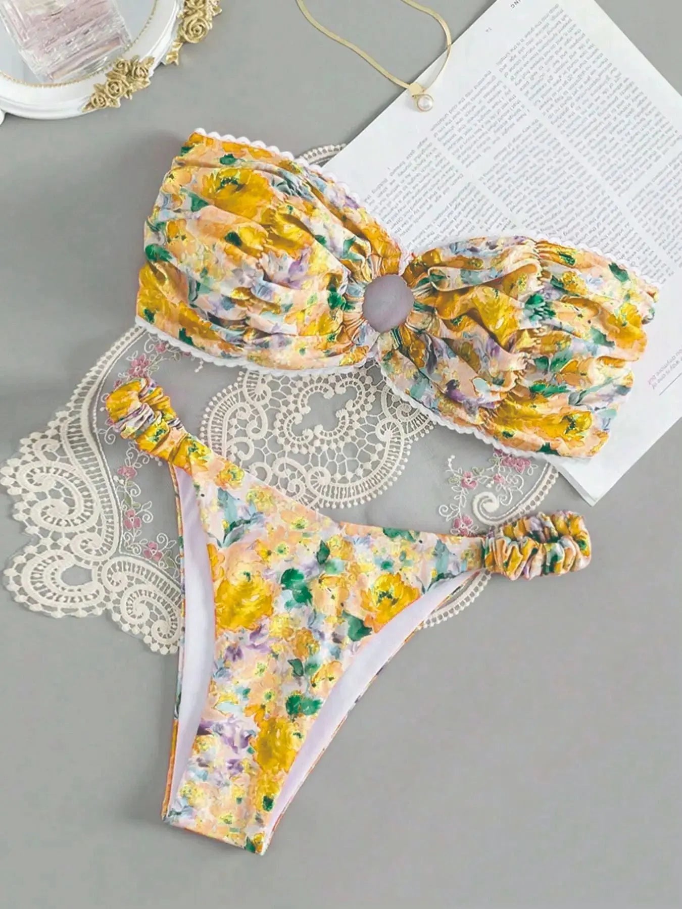 Colourful floral print tube top bikini set with lace trim on a mannequin
