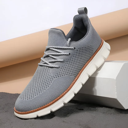 Men's grey and black low-top casual sneakers with a breathable mesh fabric upper.
