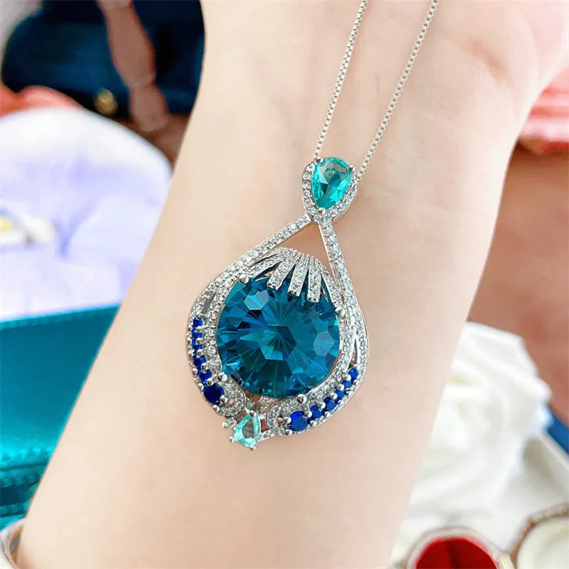 Women's blue crystal necklace with geometric fireworks-cut pendant on water wave alloy chain