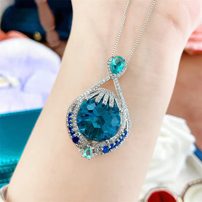 Women's blue crystal necklace with geometric fireworks-cut pendant on water wave alloy chain