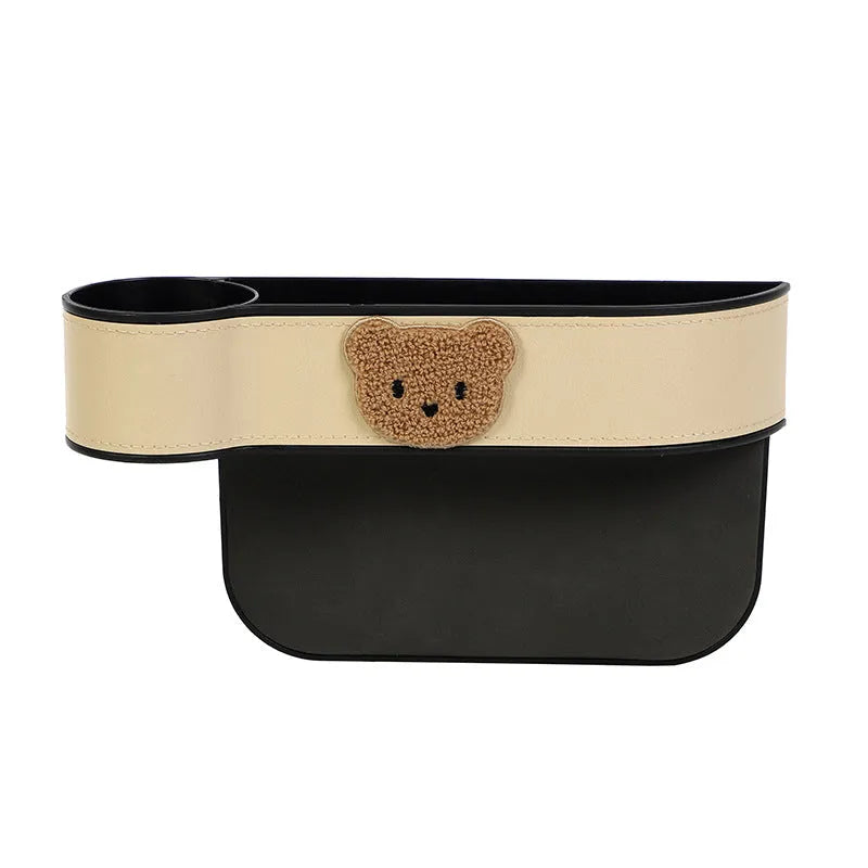 Car seat gap storage box with hanging leather construction designed for organising your vehicle interior, available in four colour variations with cartoon bear design for main driver or co-pilot seat placement.