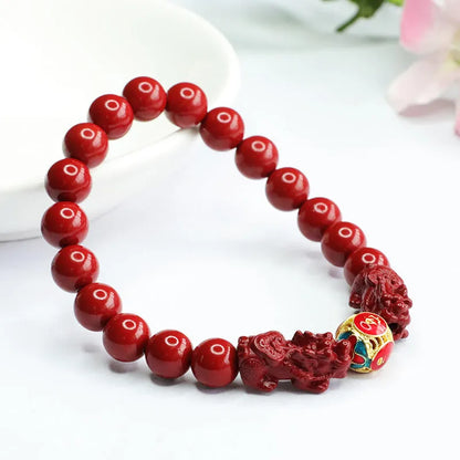 Purple gold sand cinnabar bracelet with carved double Pixiu design, 8mm beads.