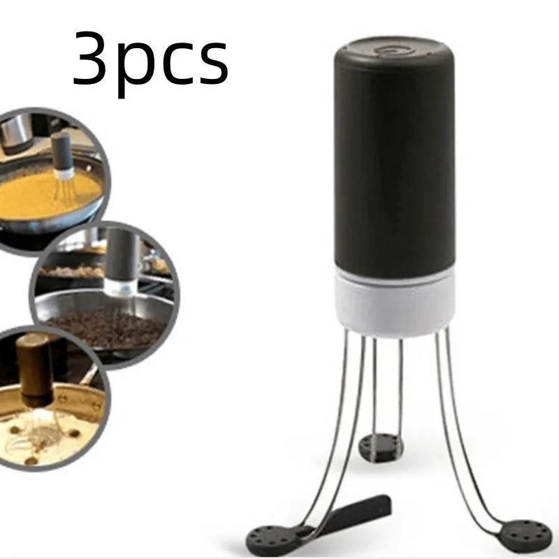 White and black wireless automatic kitchen stirrer with three-speed button, shown next to a saucepan.