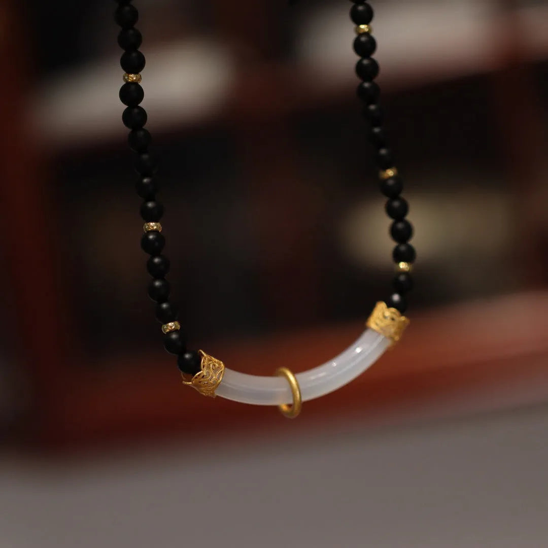 Women's Chinese style necklace with matte black agate pendant and silver ball bead chain.