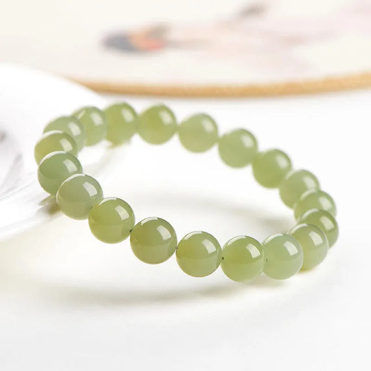 Hetian jade ball bracelet with polished spherical beads in ice-like clear water colours on wrist