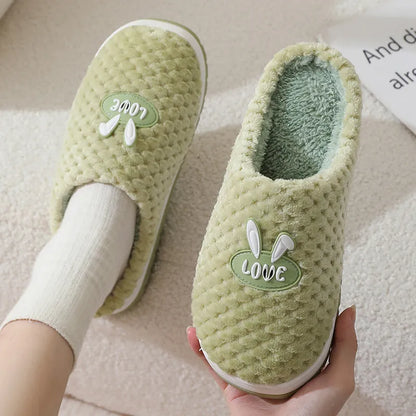 Women's plush rabbit plaid design winter slippers with a thick light-coloured rubber sole.