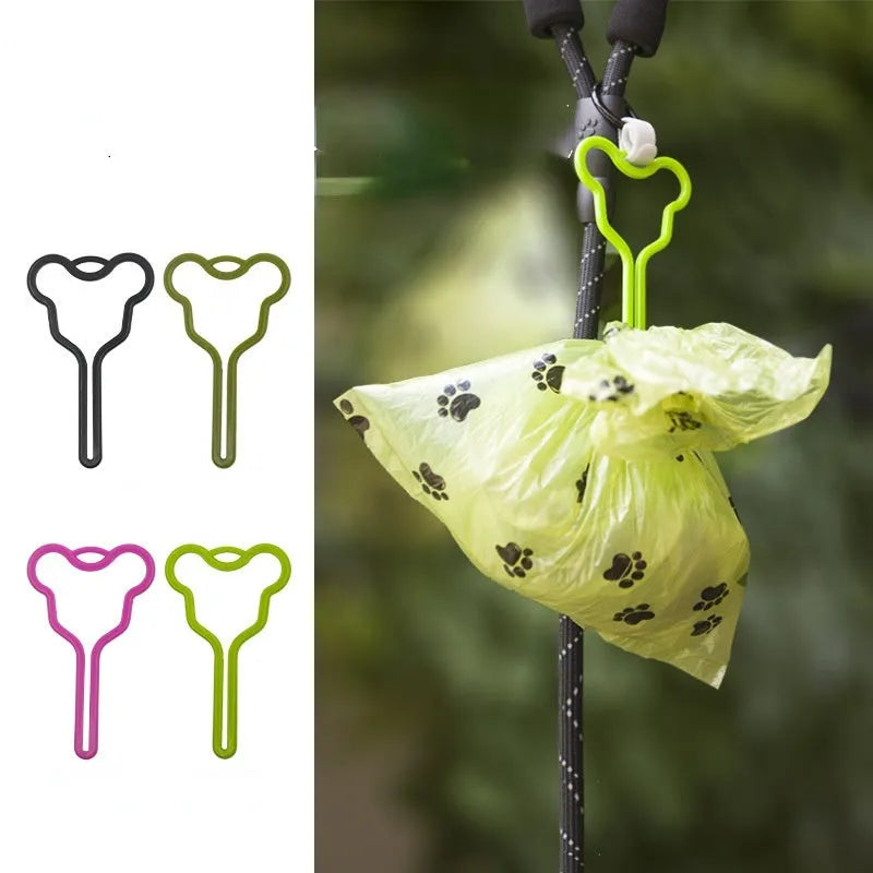 A dog poop bag dispenser with a hands-free clip and adjustable Velcro strap attached to a dog lead.