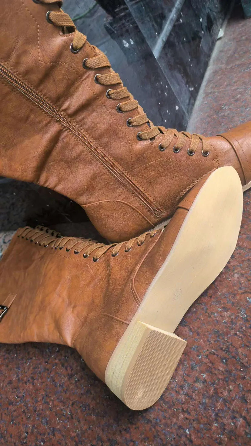 Women's black knight ankle boots with a cross strap fastening detail.