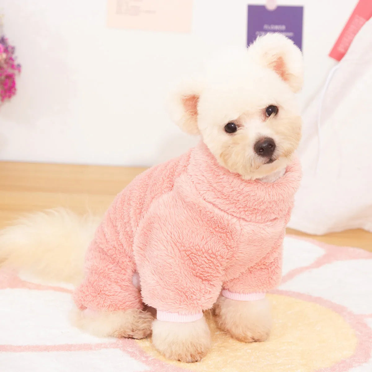 Blue double-sided plush four-legged dog clothing with high collar and towing ring laid flat.