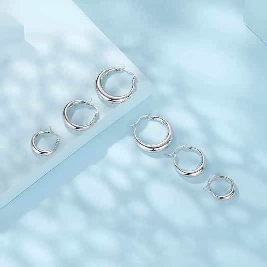 Copper alloy ear clip earrings with geometric ring design and silver posts in three sizes.