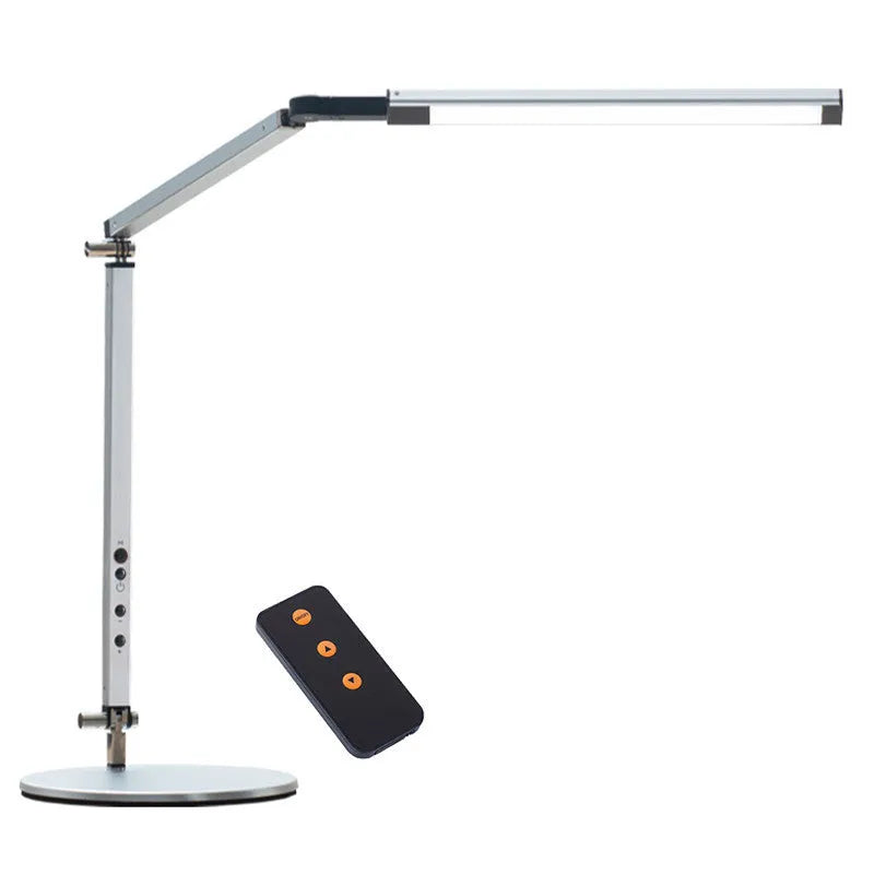 Clip-on adjustable arm LED desk lamp in black mounted on a desk edge with remote control.