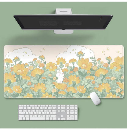 Large floral pattern mouse pad on a wooden desk with a computer mouse.