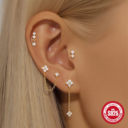 A pair of geometric clover petal stud earrings in gold-toned S925 sterling silver on a plain background.