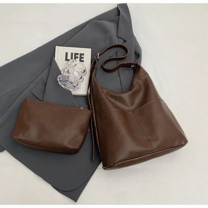 Women's soft PVC bucket shoulder bag with single strap, open pocket, phone pocket, and matching wallet