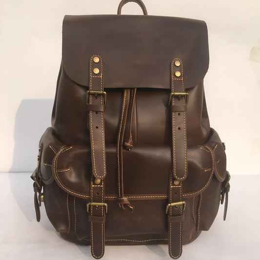 Men's brown leather backpack showing cowhide texture and air pillow belt system
