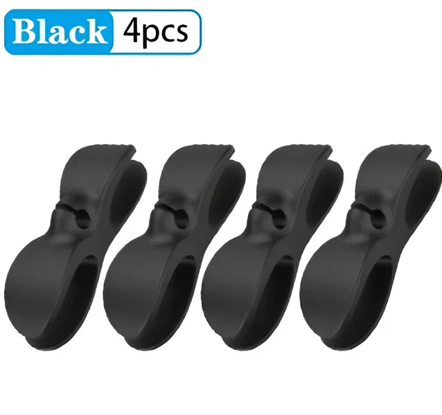 Black TPU cable organizer clips winding appliance cords on kitchen counter, 5cm size, non-marking adhesive for tidy management