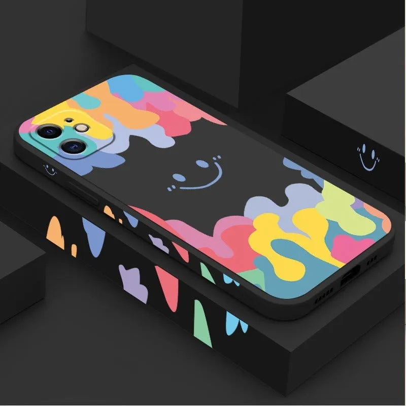 White silicone iPhone case with rainbow smiley face pattern and attached lanyard