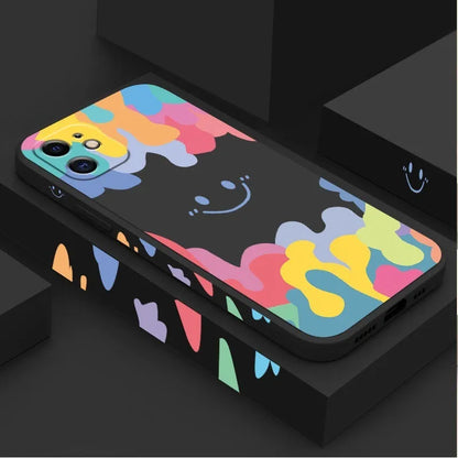 White silicone iPhone case with rainbow smiley face pattern and attached lanyard