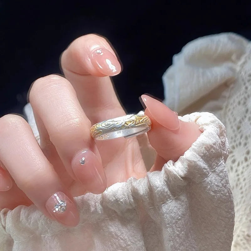 Open mouth silver and gold ring with J14 Xiangyun geometric pattern on a white copper band.
