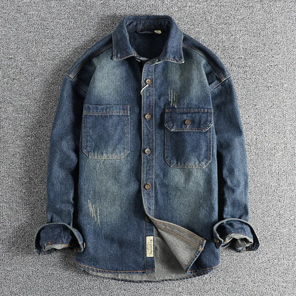 Men's light blue washed vintage denim shirt with long sleeves and a loose cardigan fit.