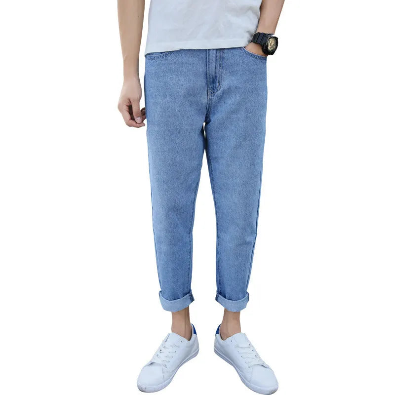 Men's black harem jeans with loose straight fit and straight leg design on a hanger