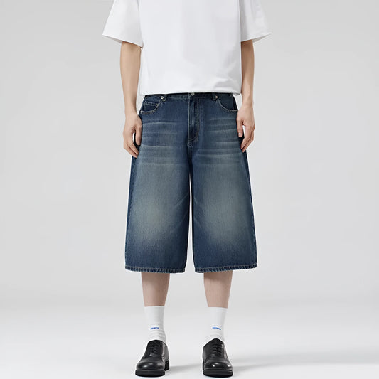 Men's loose straight denim shorts in light blue with cropped length ending above ankle, straight-leg cut