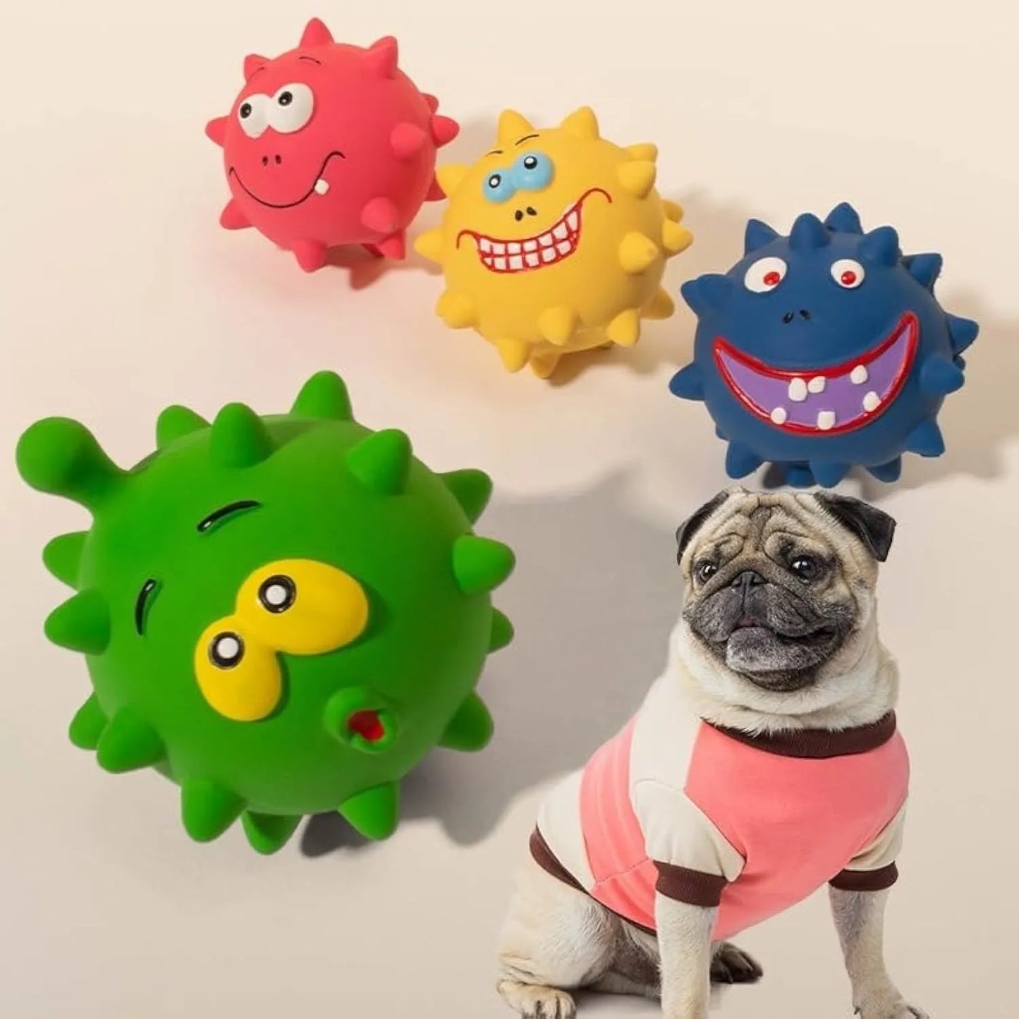 Four coloured natural latex dog balls with textured surfaces and cute faces, each measuring 7.5cm in diameter